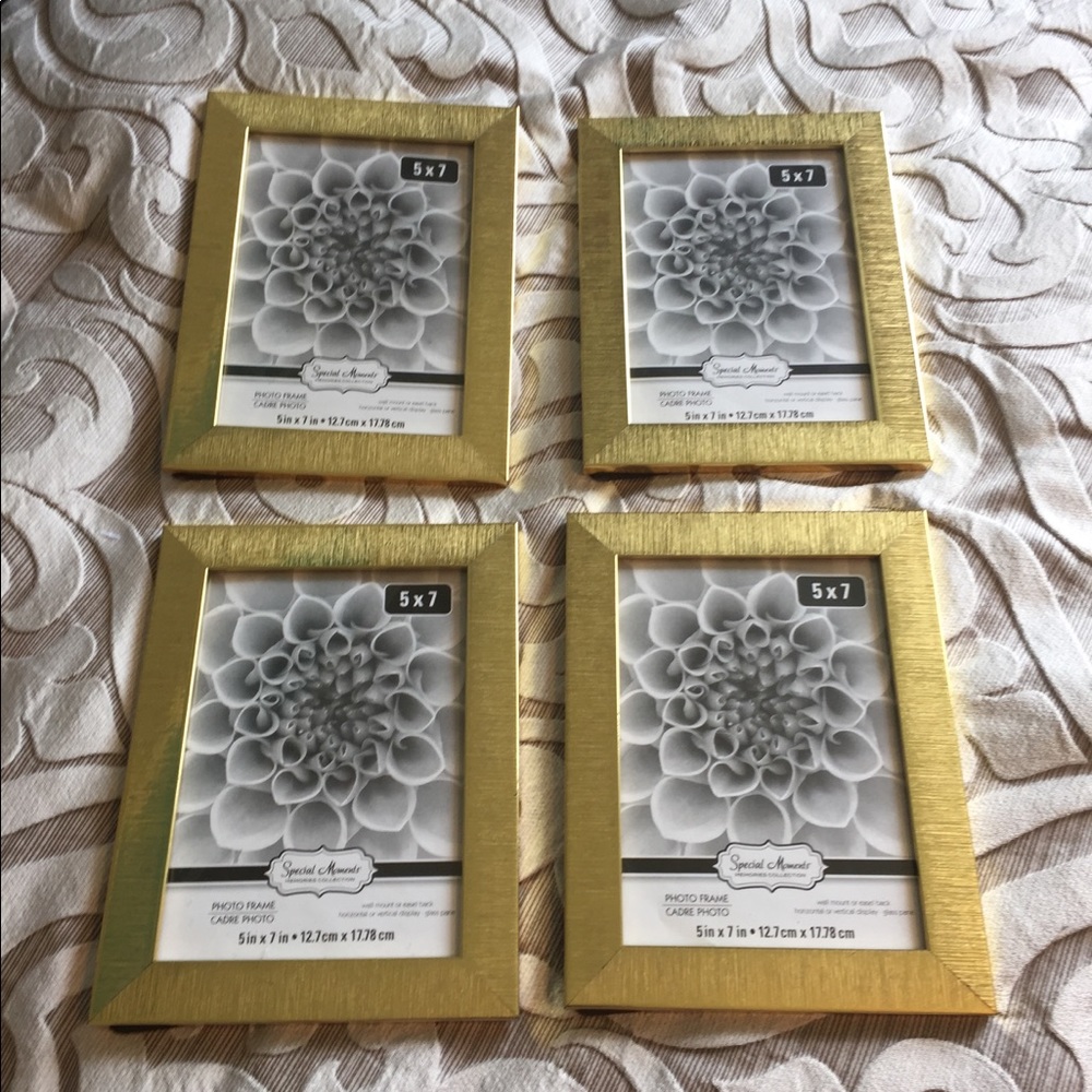 Four gold 5X7 picture frames.